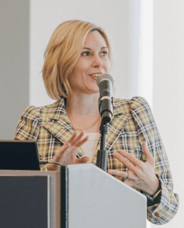 Headshot of Erin Clifford speaking at a conference.